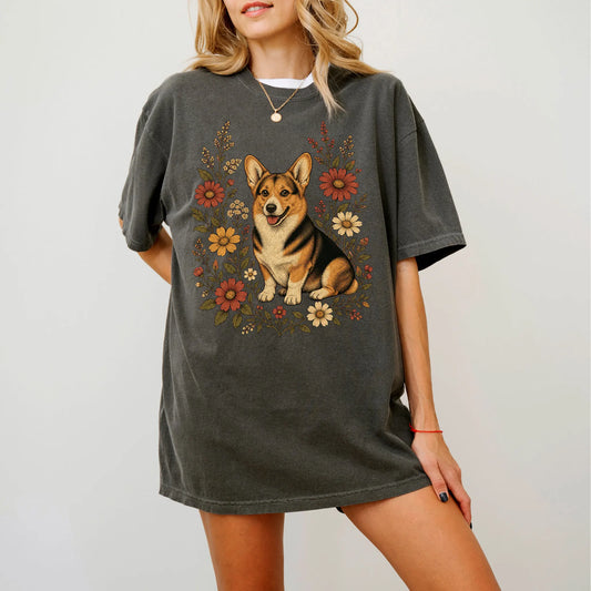 Model wearing a Pepper Comfort Colors® T-shirt showing Corgi portrait surrounded by wildflowers beneath the moon