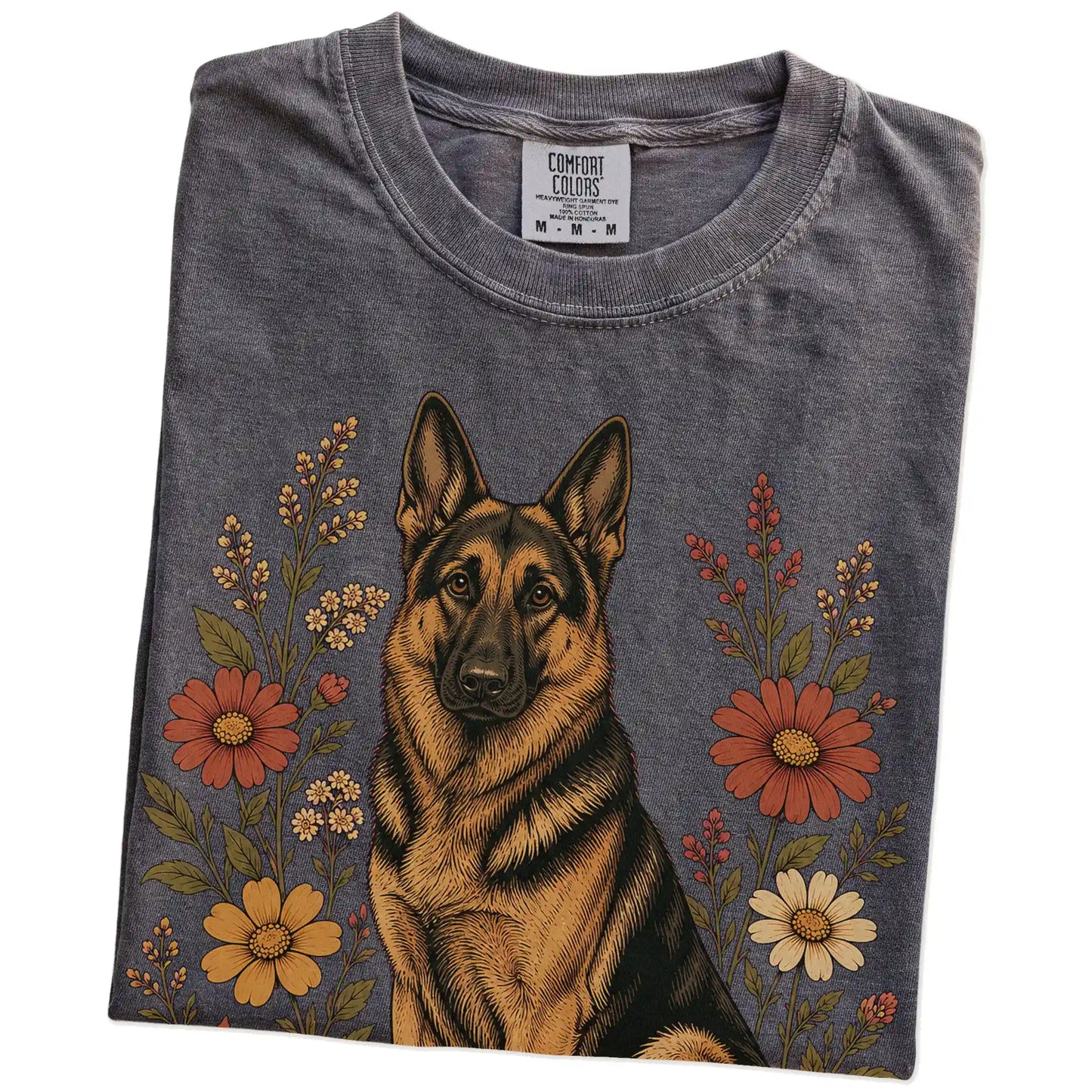 Folded Pepper Comfort Colors® T-shirt showing German Shepherd portrait surrounded by wildflowers beneath the moon