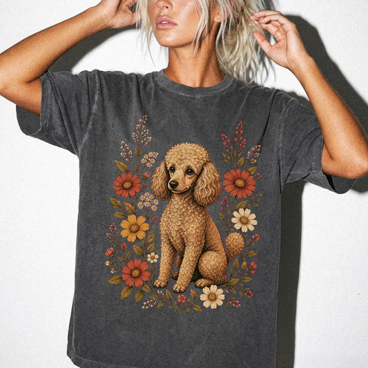 Model wearing a Pepper Comfort Colors® T-shirt showing Poodle portrait surrounded by wildflowers beneath the moon