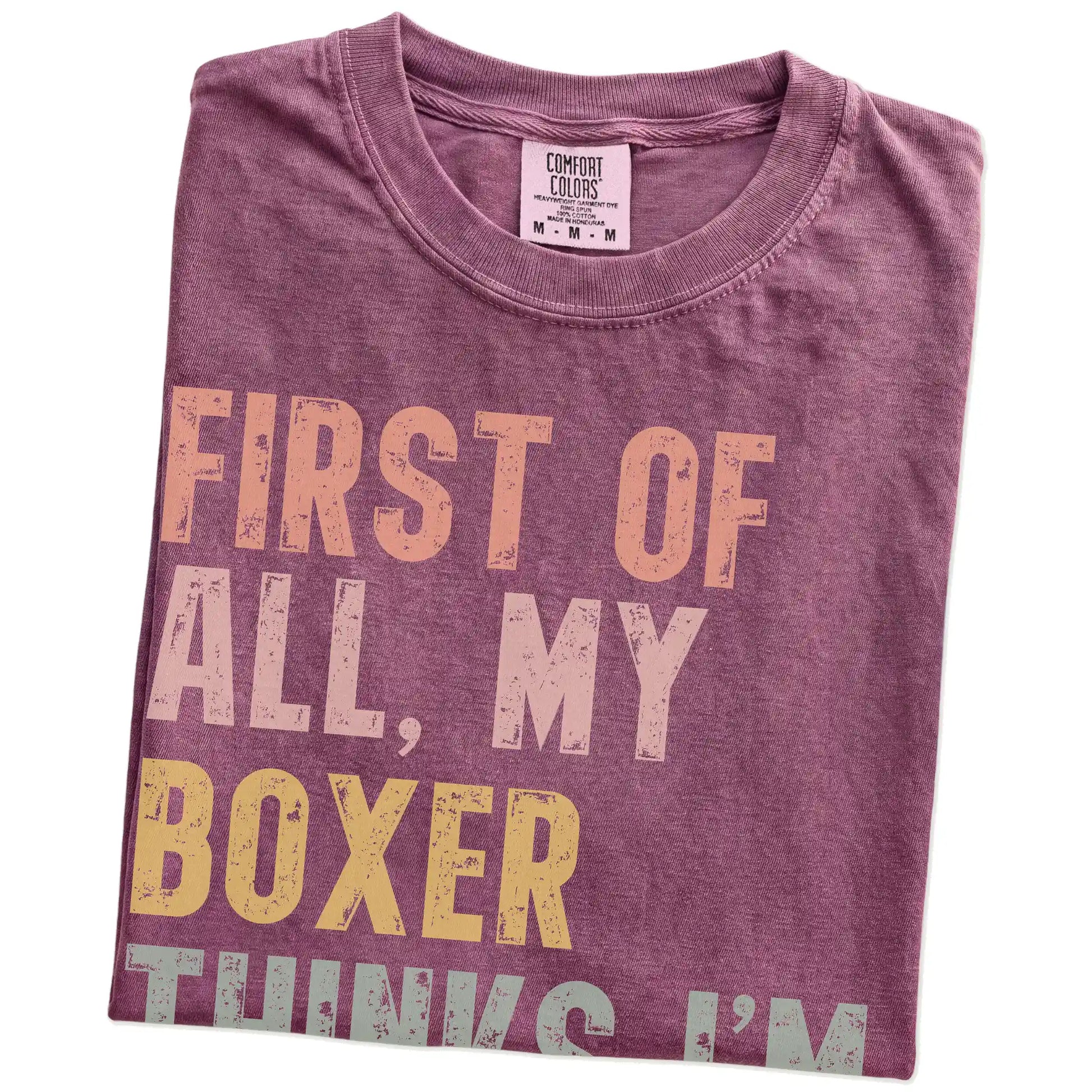 Folded Berry Comfort Colors® T-shirt showing “My Boxer thinks I’m delightful” text
