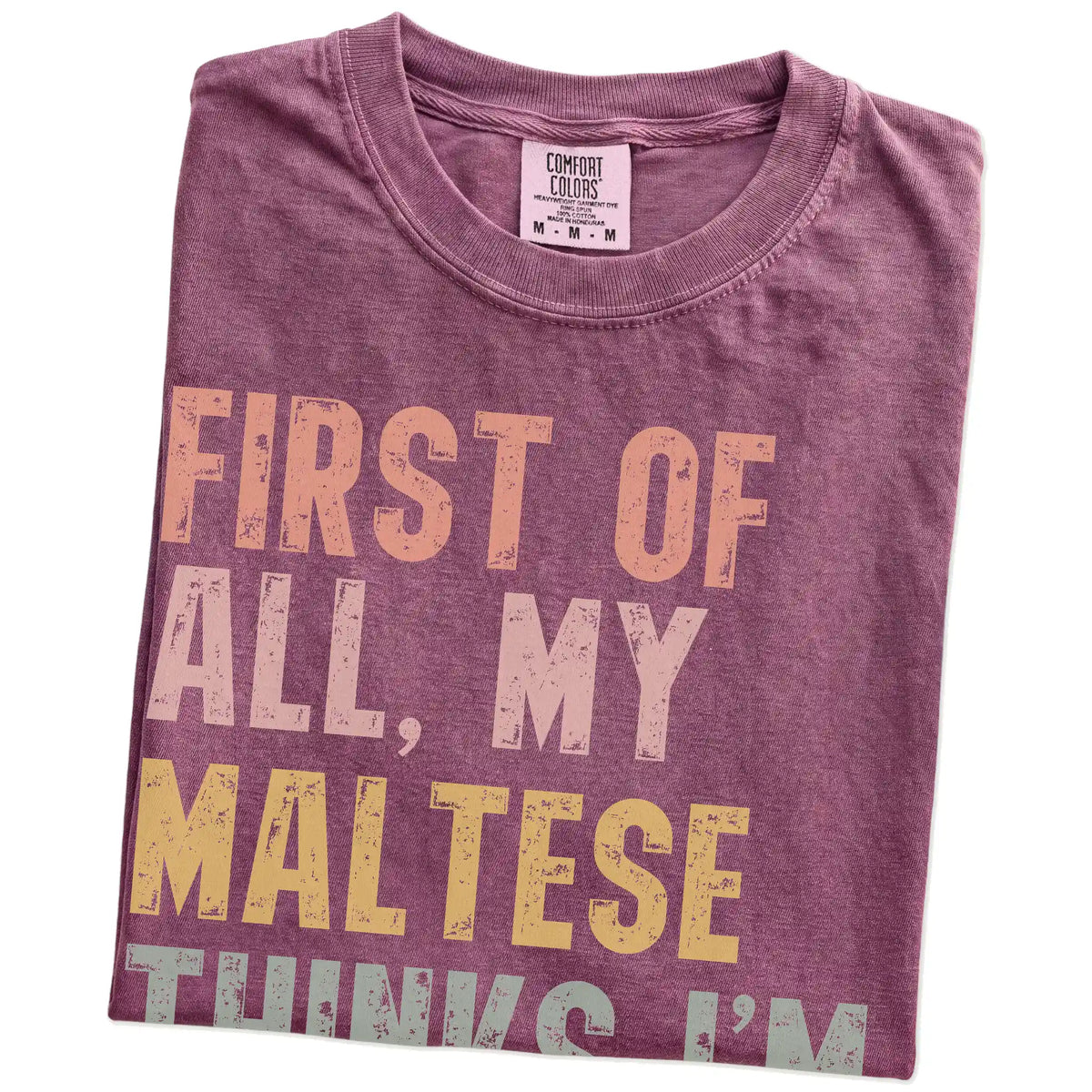 Folded Berry Comfort Colors® T-shirt showing “My Maltese thinks I’m delightful” text