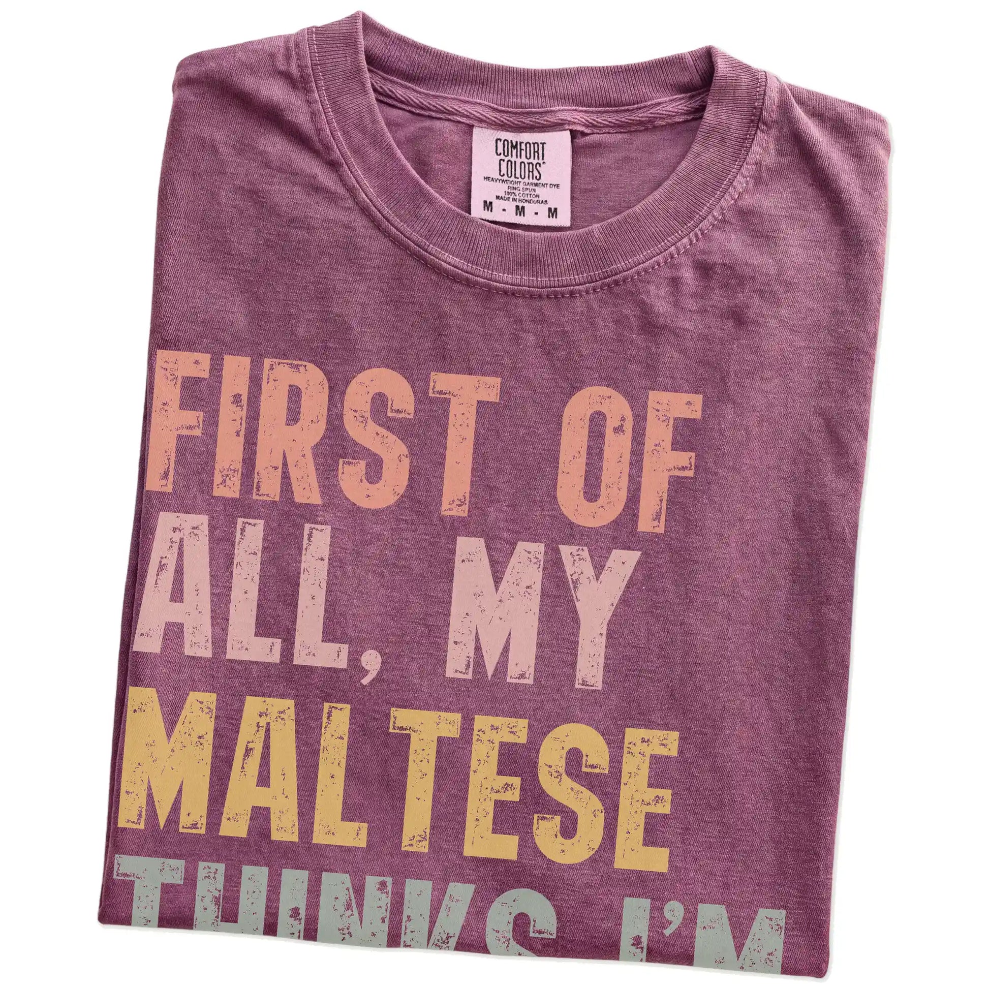 Folded Berry Comfort Colors® T-shirt showing “My Maltese thinks I’m delightful” text