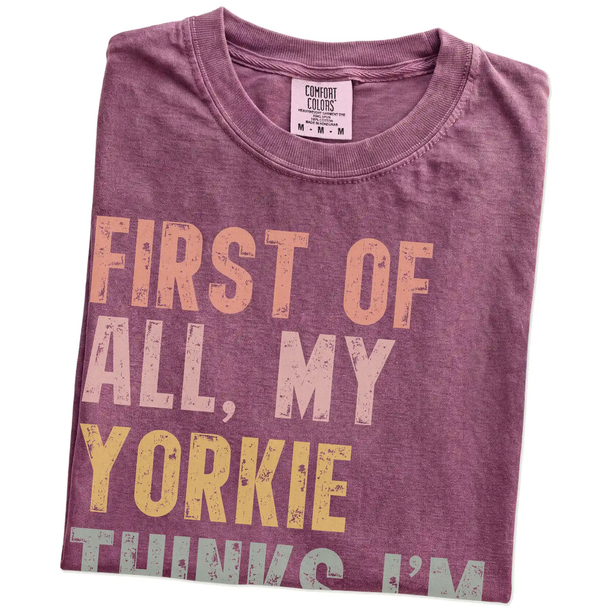 Folded Berry Comfort Colors® T-shirt showing “My Yorkie thinks I’m delightful” text
