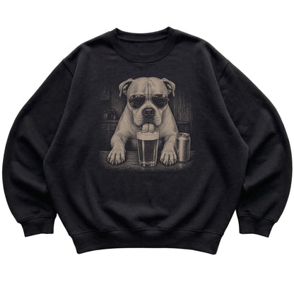 Black American Bulldog drinking from a pint at a bar, laid flat