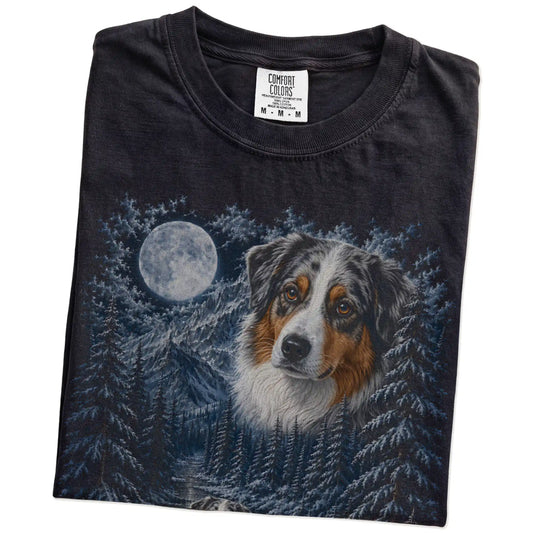 Folded black T-shirt with Australian Shepherd Winter Moon artwork.