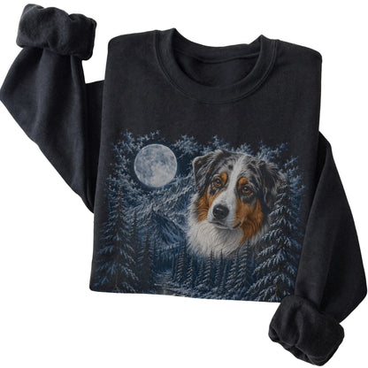 Folded black sweatshirt with Australian Shepherd Winter Moon artwork.