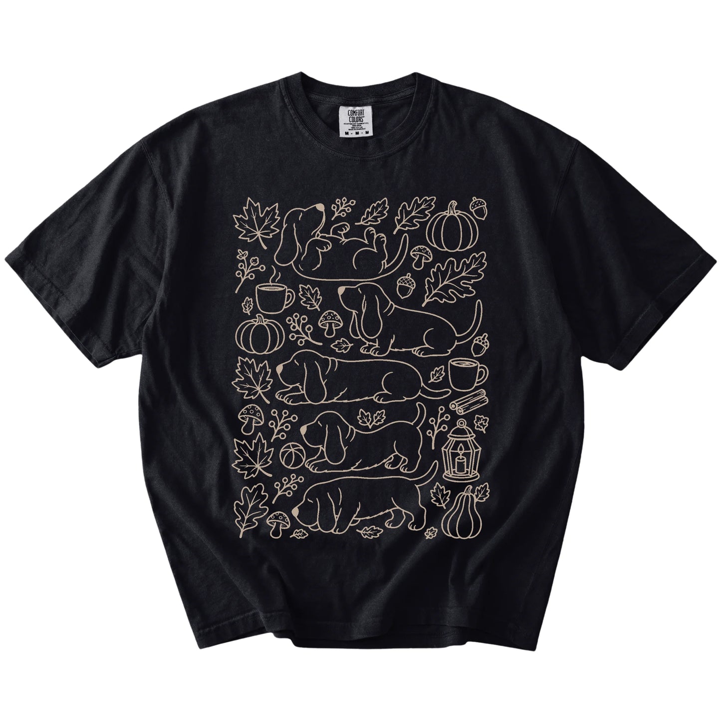 Basset Hound dogs with pumpkins, leaves, acorns, and woodland details on a Black Comfort Colors® T-shirt