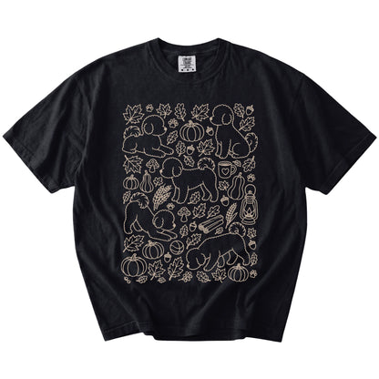 Bichon Frise dogs with pumpkins, leaves, acorns, and woodland details on a Black Comfort Colors® T-shirt