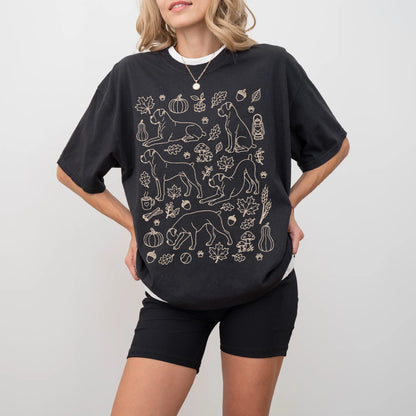 Model wearing a Black Comfort Colors® T-shirt with Boxer dogs with pumpkins, leaves, acorns, and woodland details