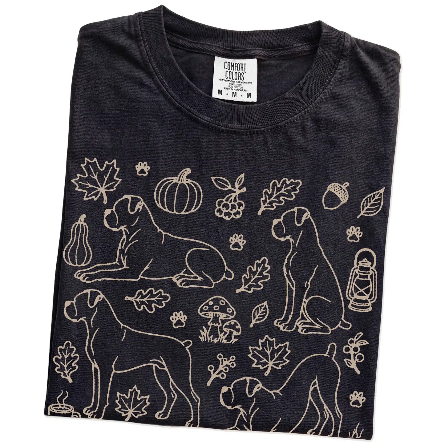 Folded Black Comfort Colors® T-shirt showing Boxer dogs with pumpkins, leaves, acorns, and woodland details