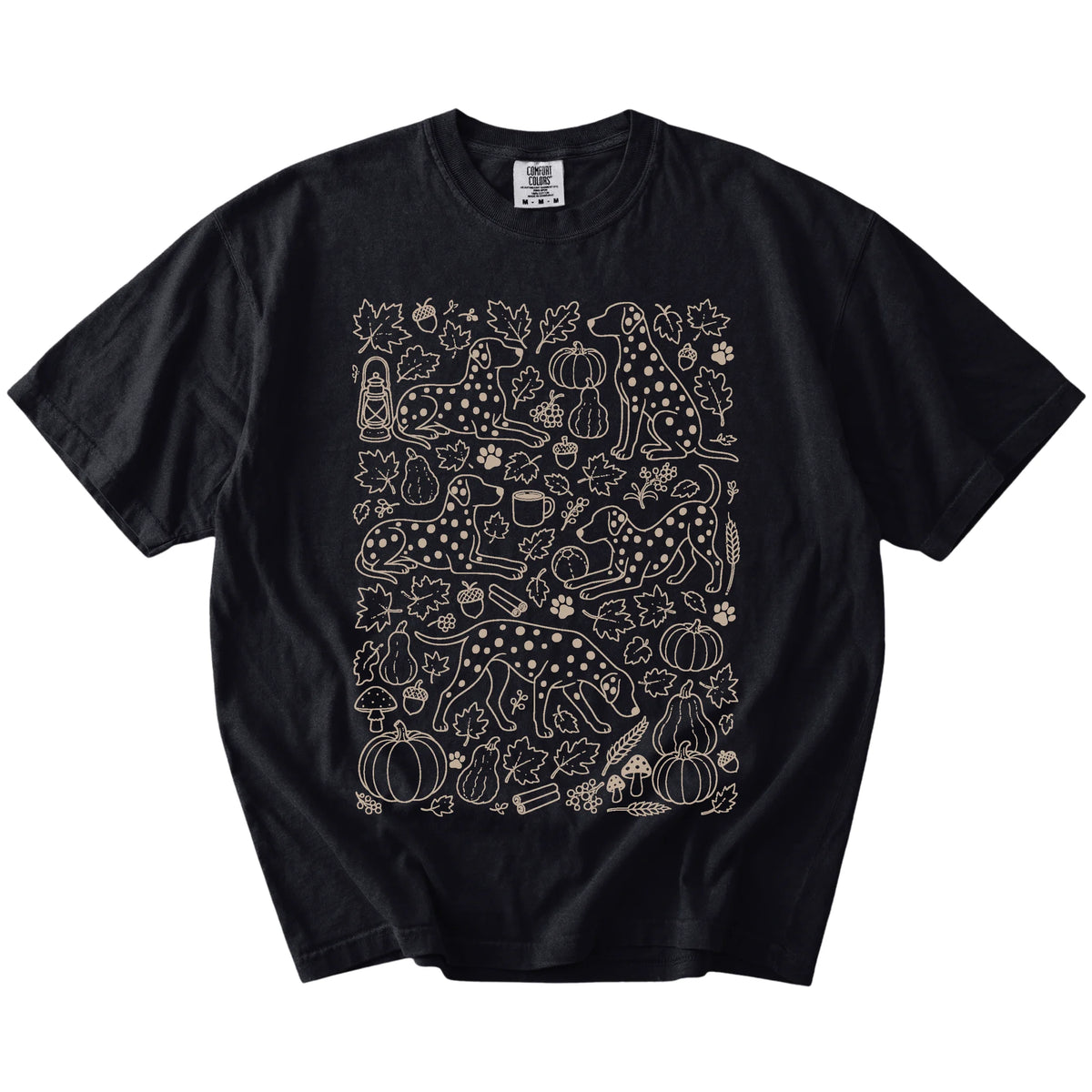 Dalmatian dogs with pumpkins, leaves, acorns, and woodland details on a Black Comfort Colors® T-shirt