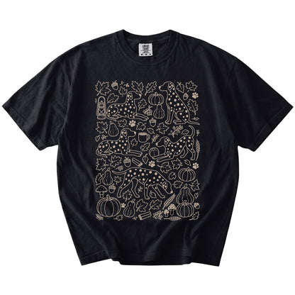 Dalmatian dogs with pumpkins, leaves, acorns, and woodland details on a Black Comfort Colors® T-shirt