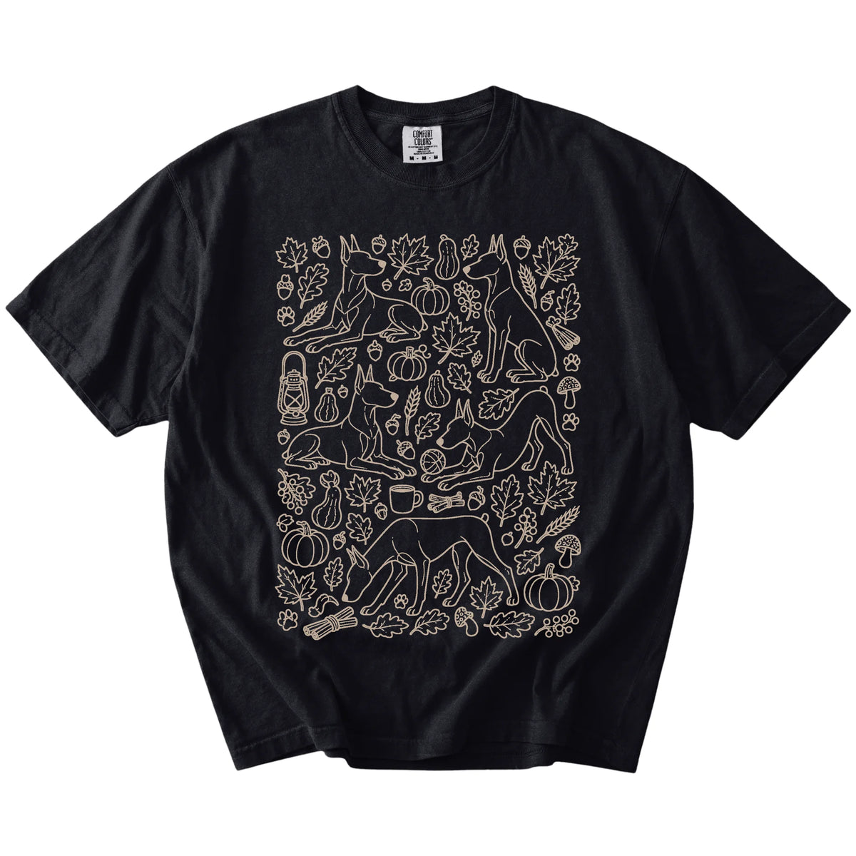 Doberman dogs with pumpkins, leaves, acorns, and woodland details on a Black Comfort Colors® T-shirt