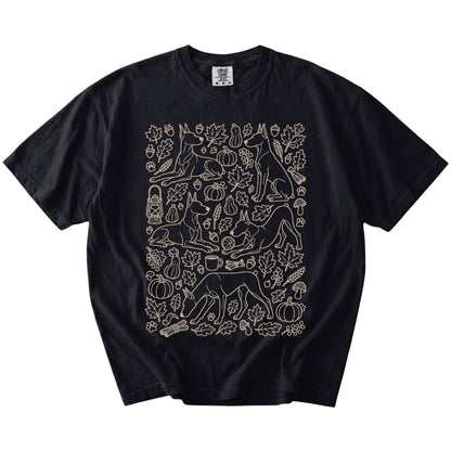 Doberman dogs with pumpkins, leaves, acorns, and woodland details on a Black Comfort Colors® T-shirt