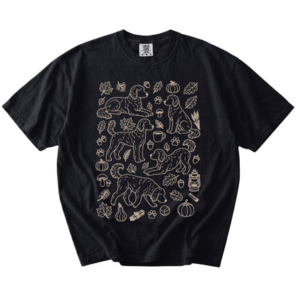 Goldendoodle dogs with pumpkins, leaves, acorns, and woodland details on a Black Comfort Colors® T-shirt
