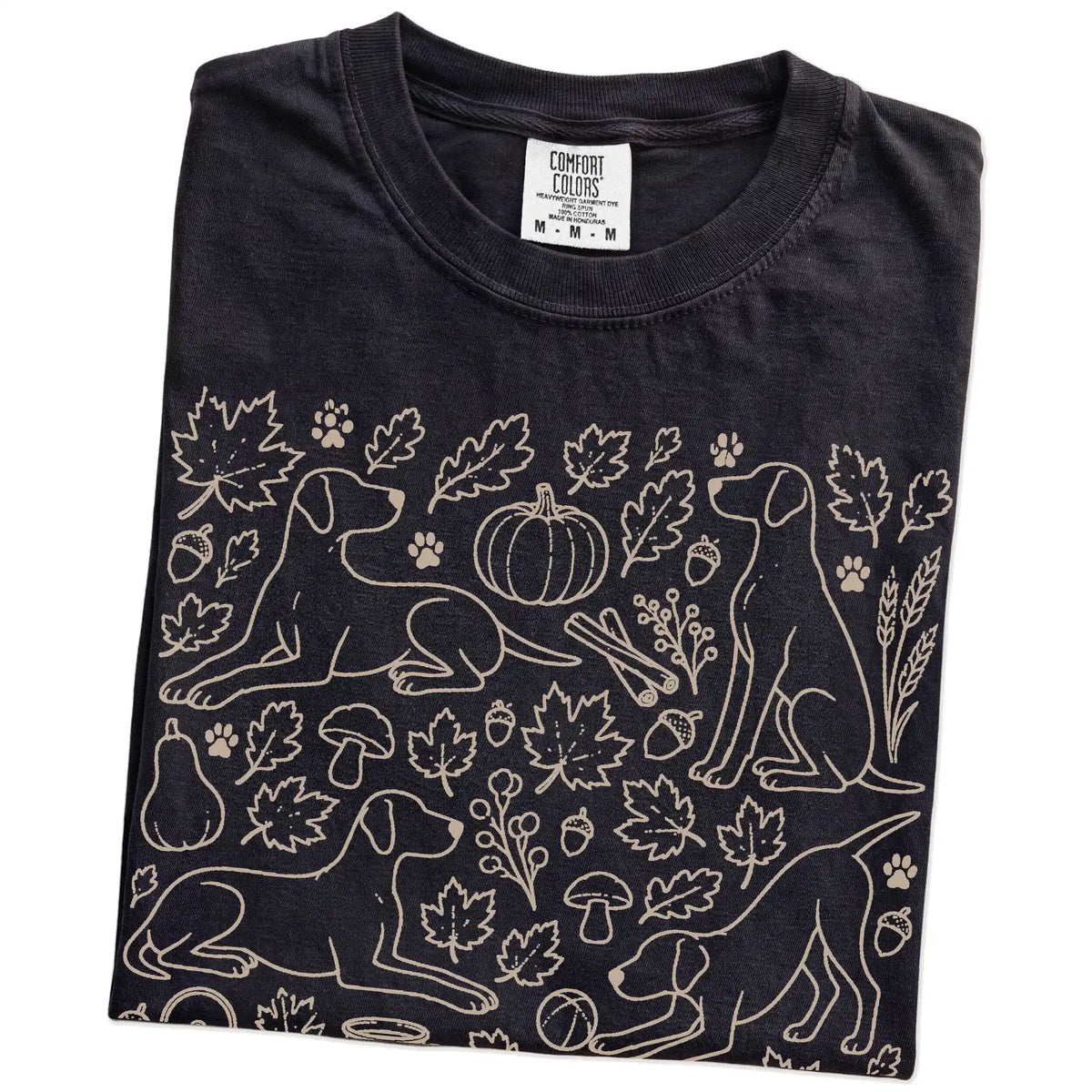 Folded Black Comfort Colors® T-shirt showing Pointer dogs with pumpkins, leaves, acorns, and woodland details