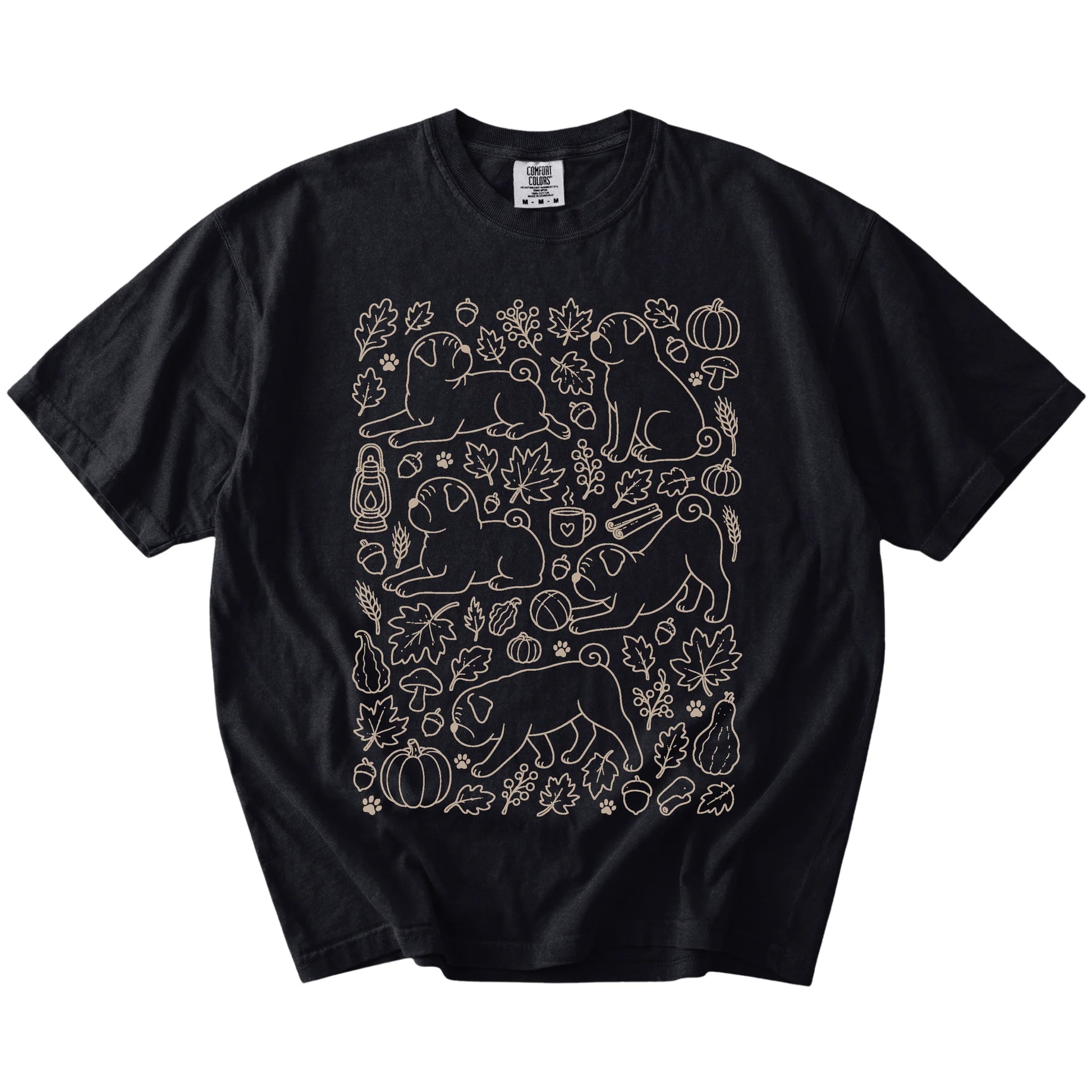 Pug dogs with pumpkins, leaves, acorns, and woodland details on a Black Comfort Colors® T-shirt