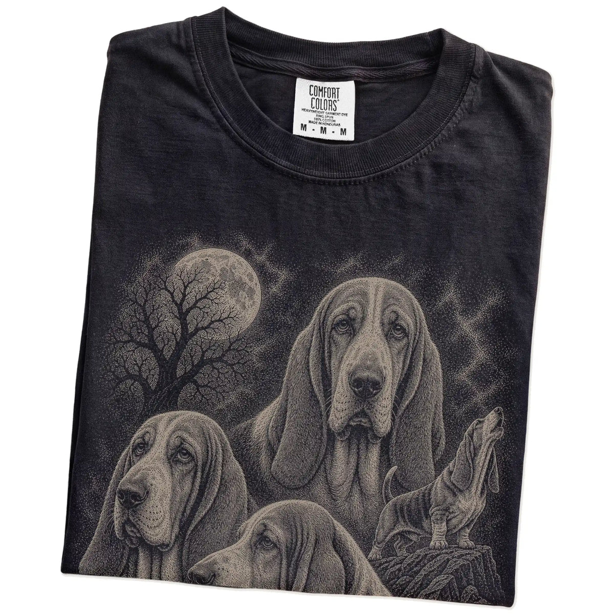 Folded Black Comfort Colors® T-shirt showing a vintage moon montage featuring Basset Hound