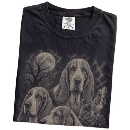 Folded Black Comfort Colors® T-shirt showing a vintage moon montage featuring Basset Hound