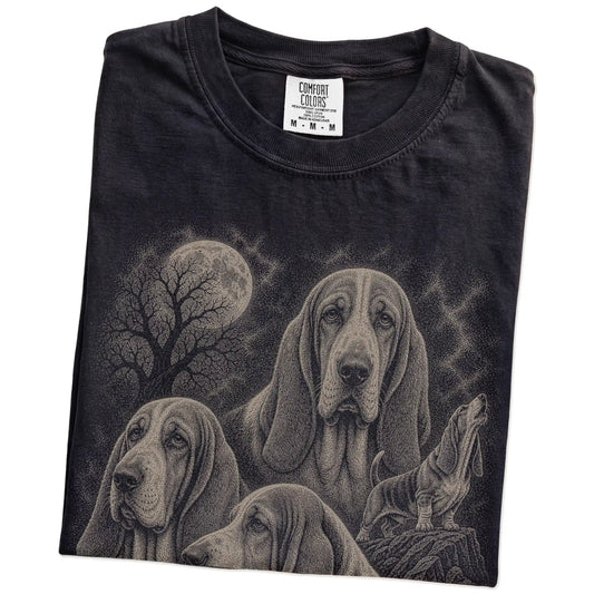 Folded Black Comfort Colors® T-shirt showing a vintage moon montage featuring Basset Hound