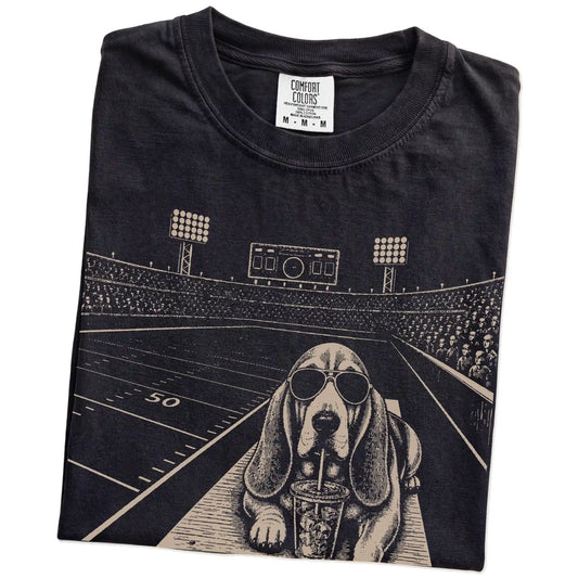 Folded Black Comfort Colors® T-shirt showing Basset Hound ready for football and tailgate season