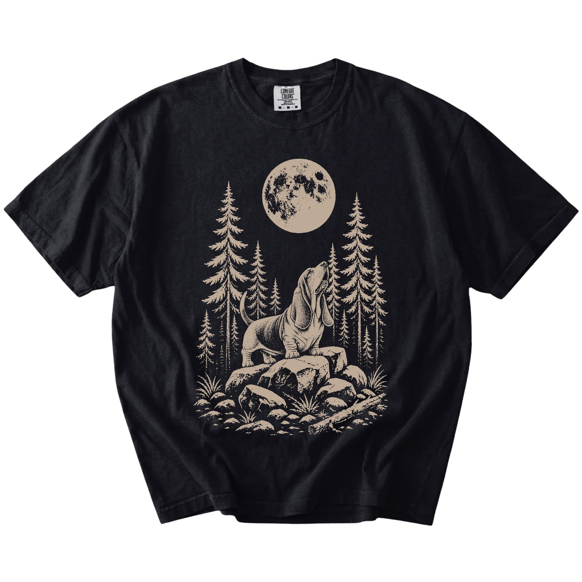 Basset Hound howling beneath the moon and pine trees on a Black Comfort Colors® T-shirt