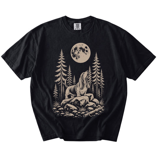 Basset Hound howling beneath the moon and pine trees on a Black Comfort Colors® T-shirt