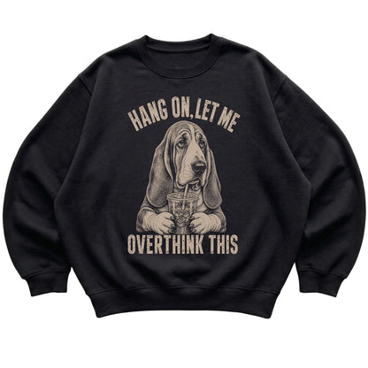 Black crewneck sweatshirt featuring Overthinking Basset Hound, laid-flat presentation