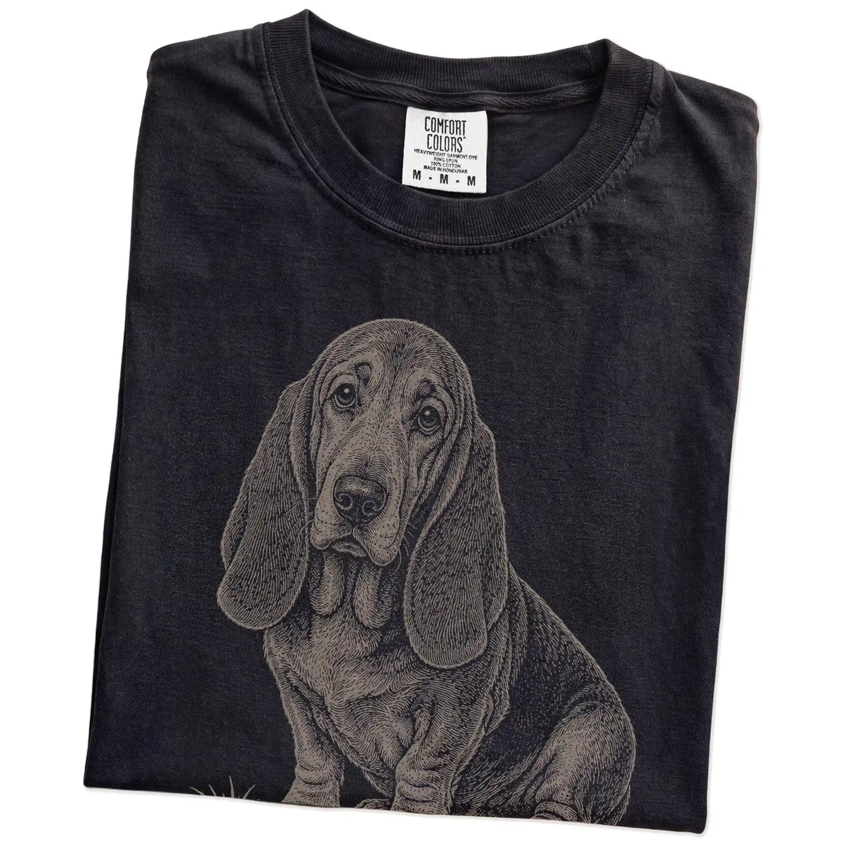 Folded Black Basset Hound Karma T-Shirt showing the graphic