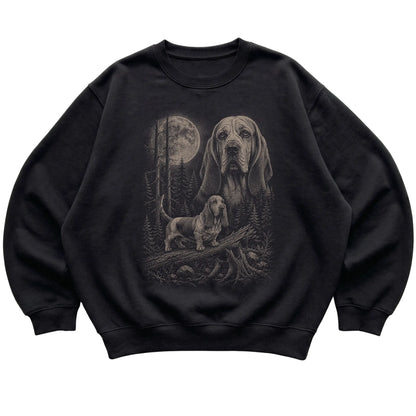 Basset Hound Moonlit Forest graphic on a black crewneck sweatshirt laid flat