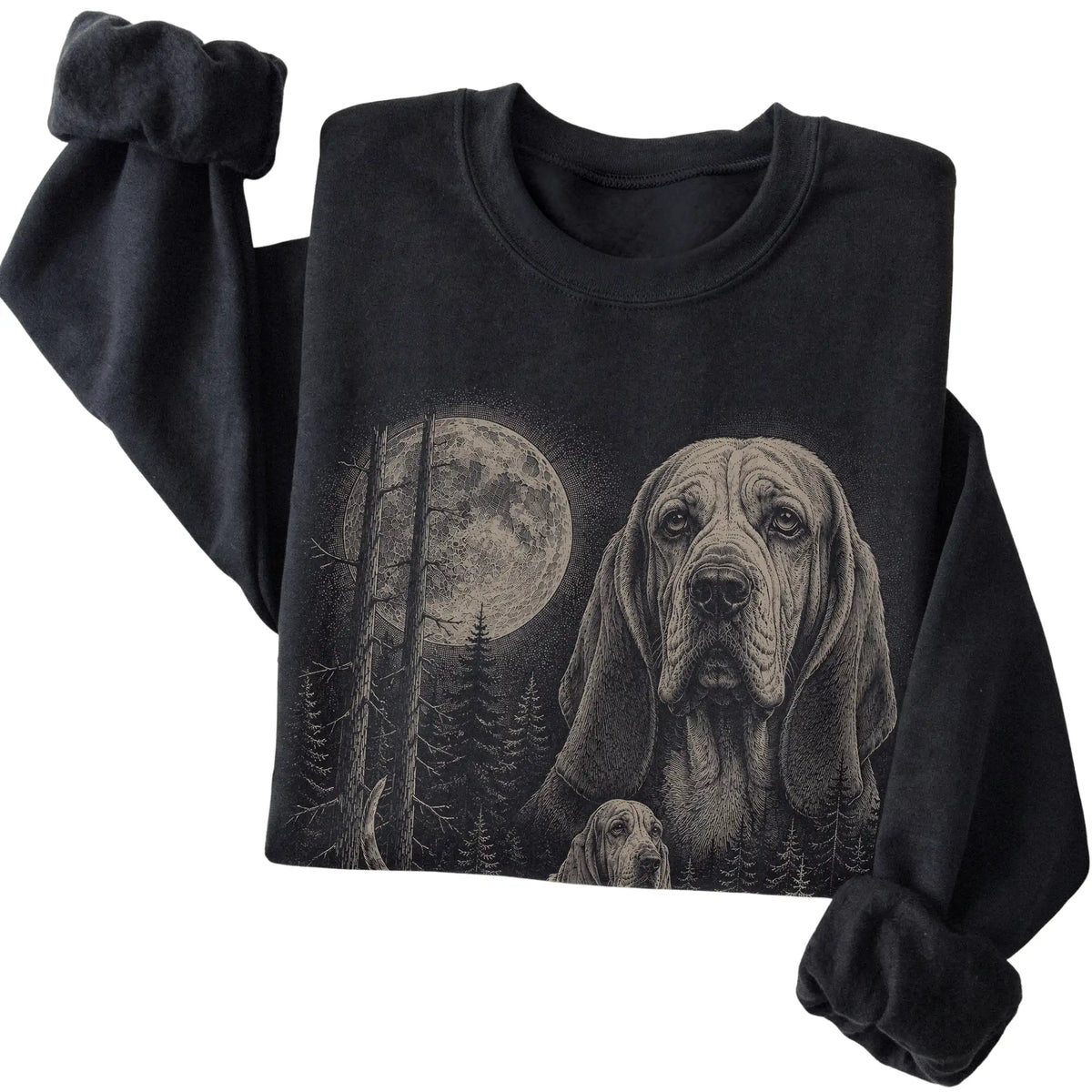 Folded black crewneck sweatshirt showing the Basset Hound Moonlit Forest graphic