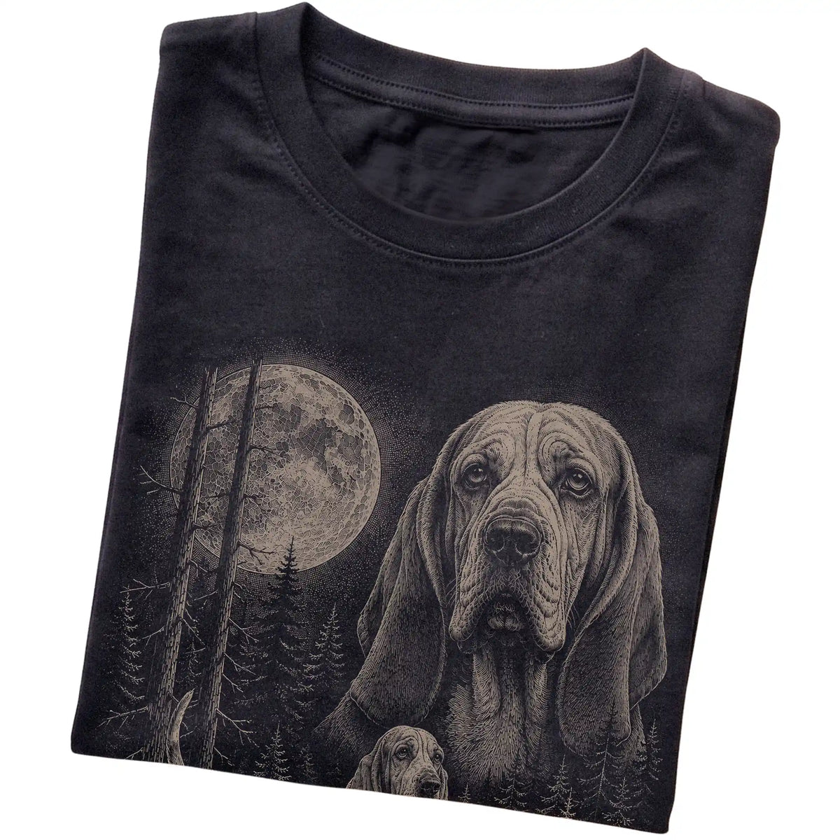Folded black Softstyle T-shirt showing the Basset Hound Moonlit Forest graphic