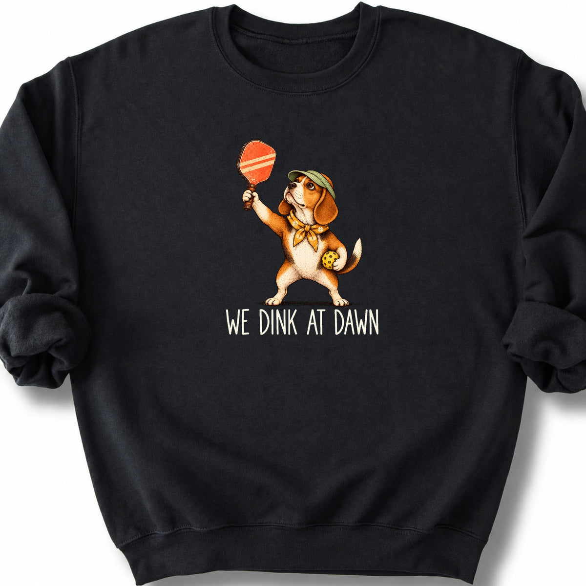 Beagle with a pickleball paddle and ball on a Black Gildan® sweatshirt with We Dink at Dawn text
