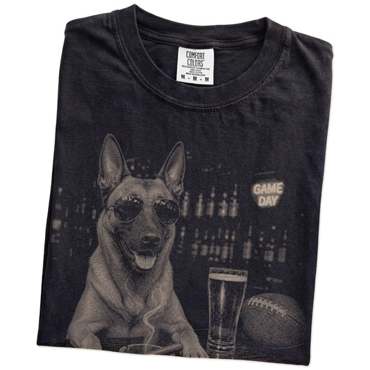 Folded Black Comfort Colors® T-shirt showing Belgian Malinois with beer and football graphics