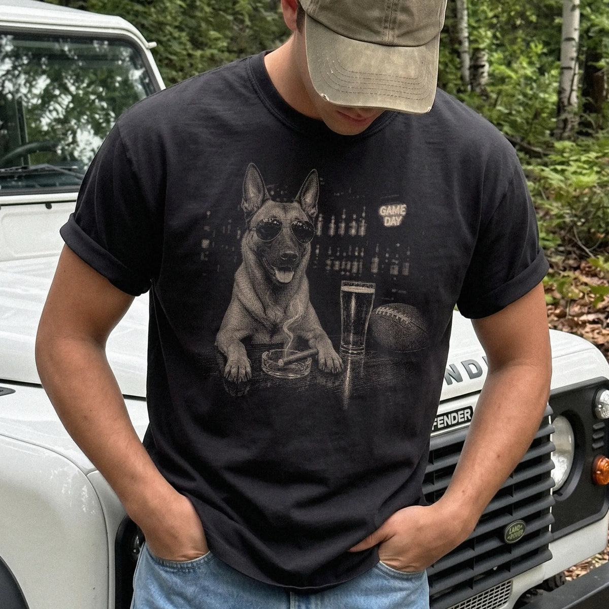 Model wearing a Black Comfort Colors® T-shirt featuring Belgian Malinois with beer and football graphics