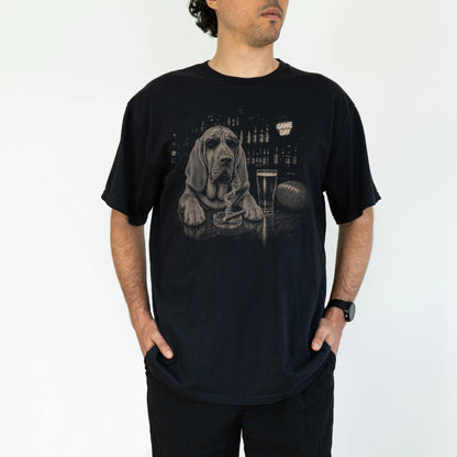 Model wearing a Black Comfort Colors® T-shirt featuring Bloodhound with beer and football graphics