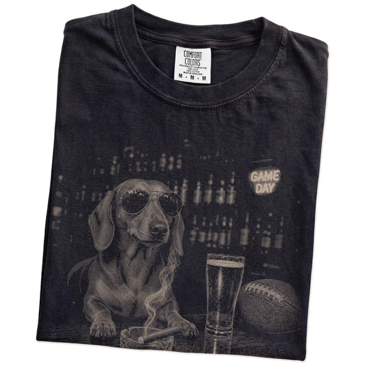 Folded Black Comfort Colors® T-shirt showing Dachshund with beer and football graphics