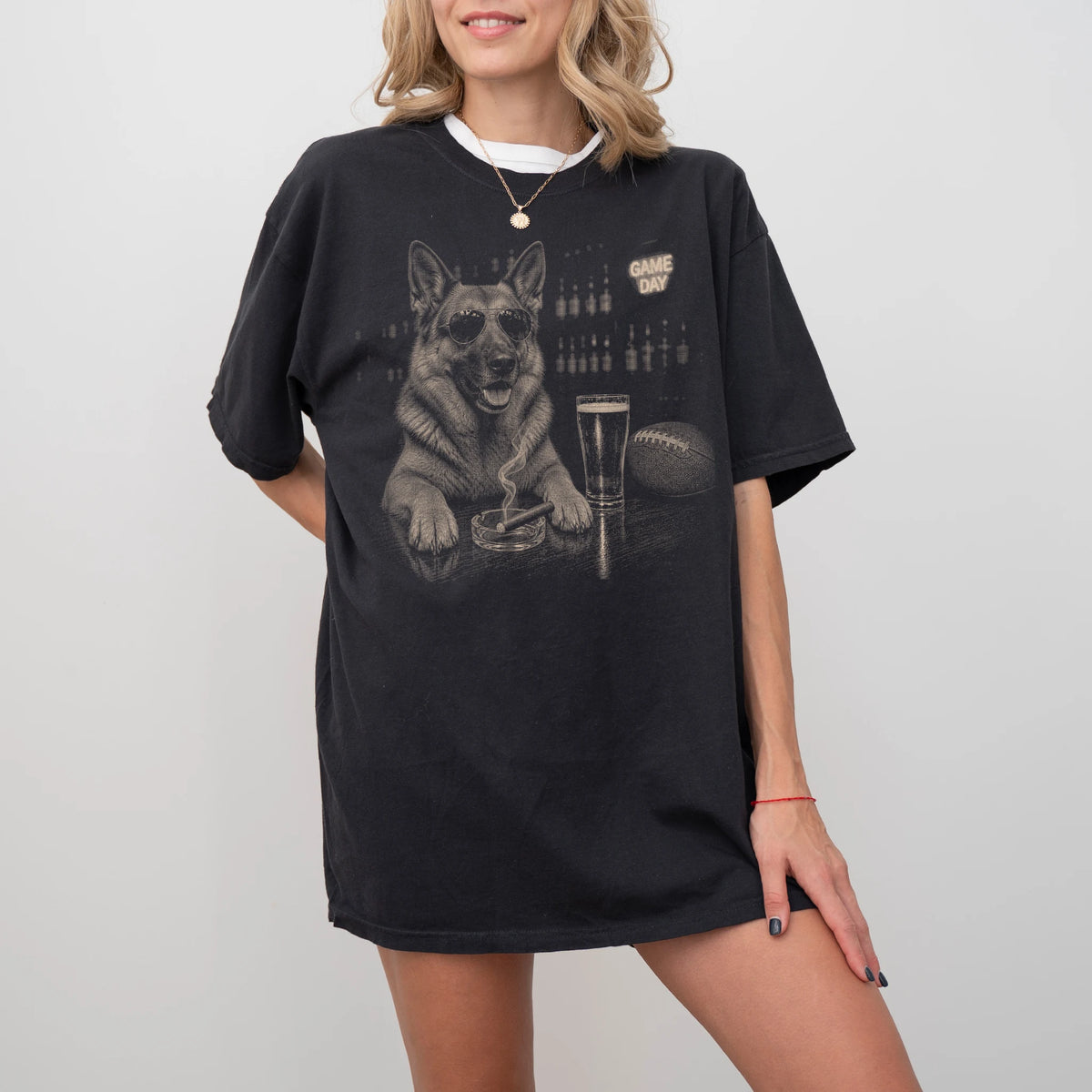 Model wearing a Black Comfort Colors® T-shirt featuring German Shepherd with beer and football graphics