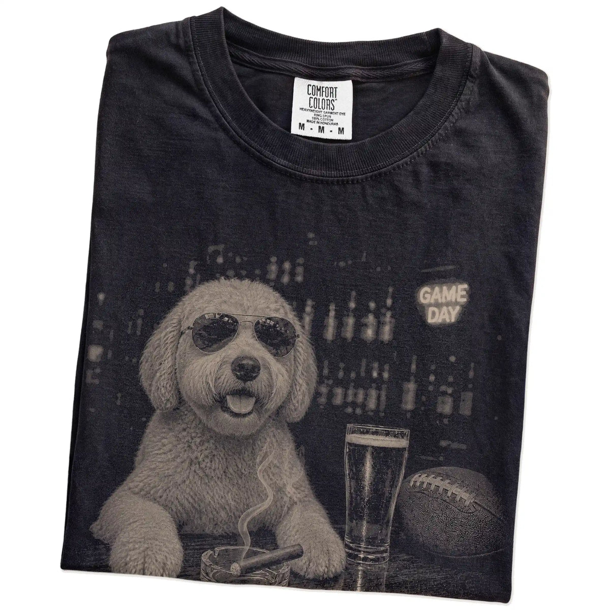 Folded Black Comfort Colors® T-shirt showing Goldendoodle with beer and football graphics