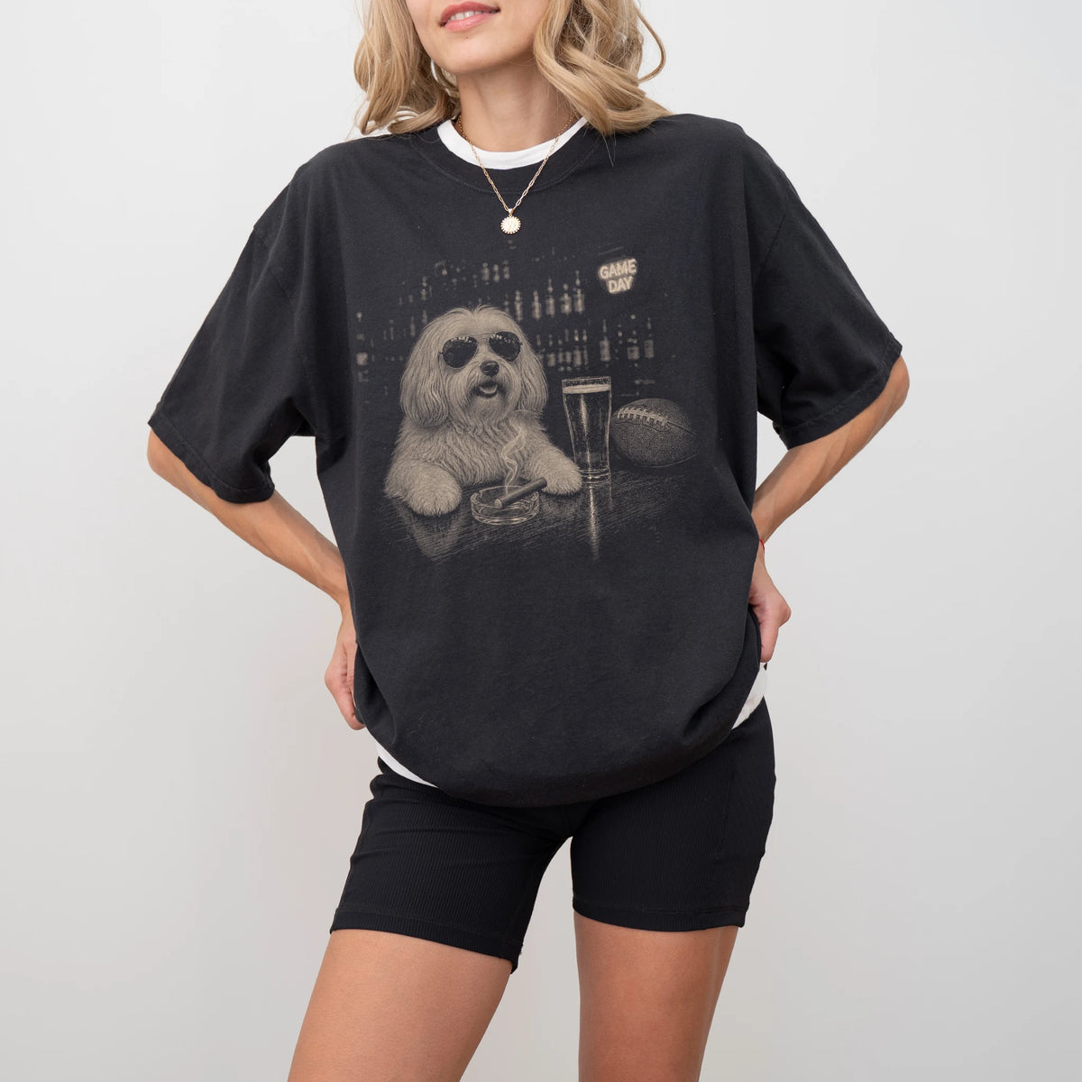 Model wearing a Black Comfort Colors® T-shirt featuring Havanese with beer and football graphics