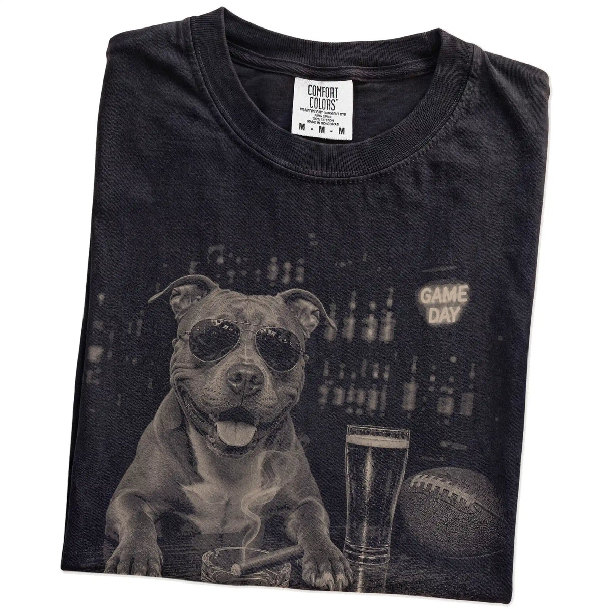 Folded Black Comfort Colors® T-shirt showing Pitbull with beer and football graphics