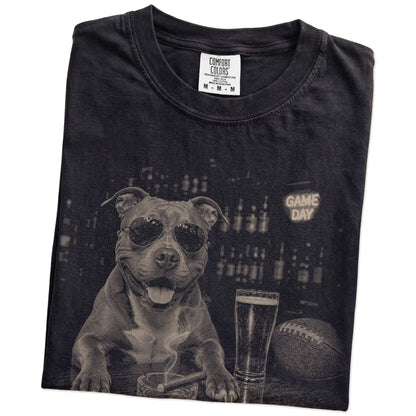 Folded Black Comfort Colors® T-shirt showing Pitbull with beer and football graphics
