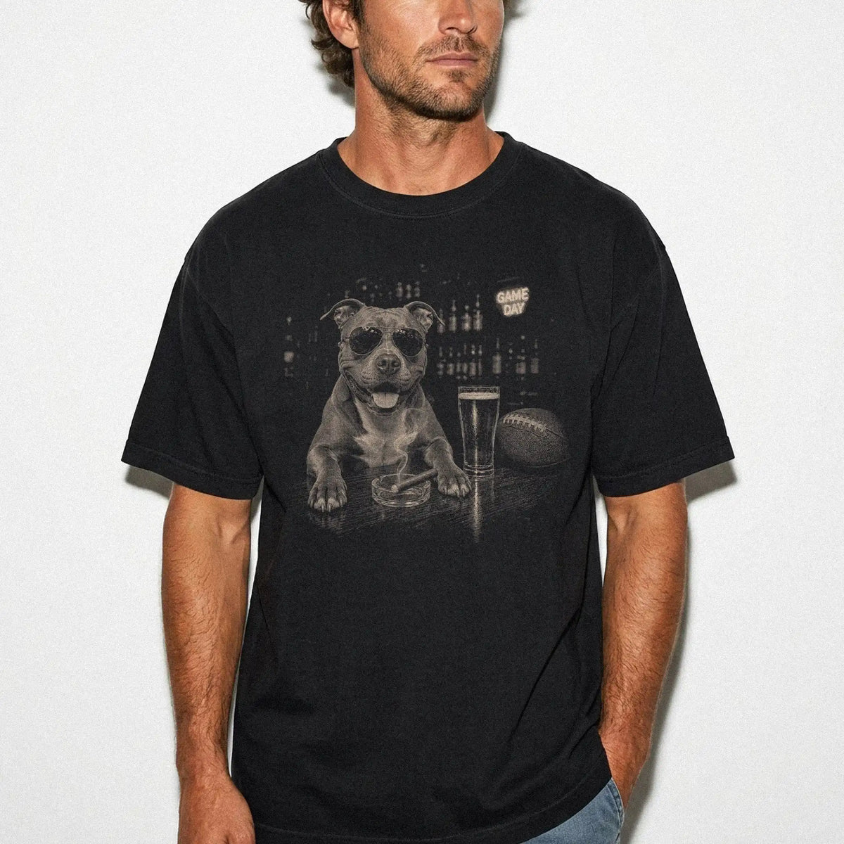Model wearing a Black Comfort Colors® T-shirt featuring Pitbull with beer and football graphics
