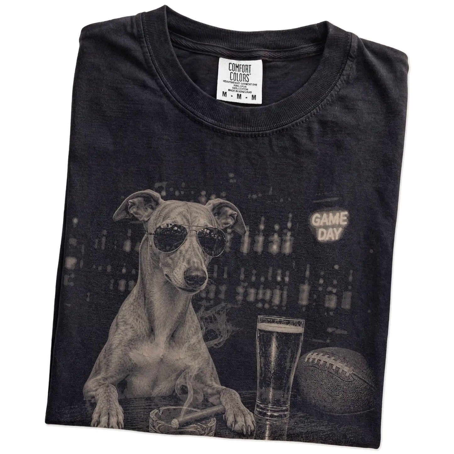 Folded Black Comfort Colors® T-shirt showing Whippet with beer and football graphics