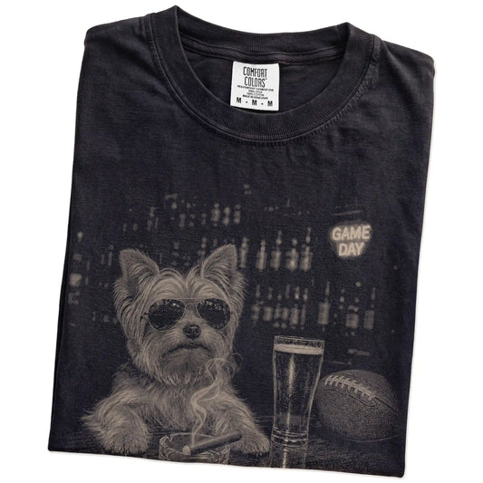 Folded Black Comfort Colors® T-shirt showing Yorkie with beer and football graphics