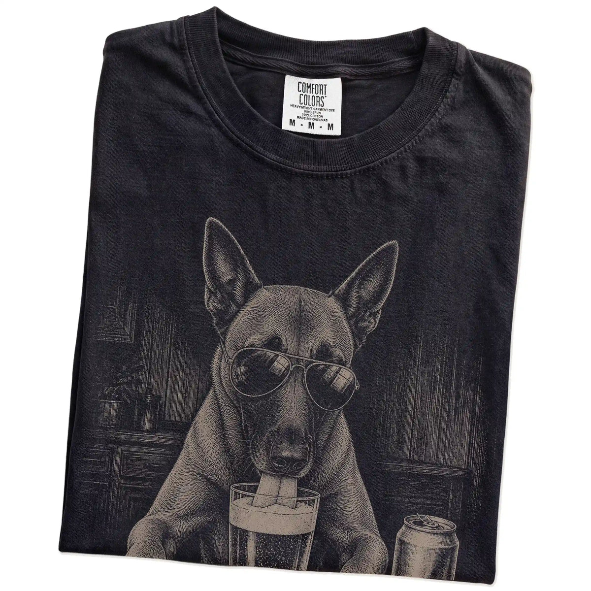 Folded Black Comfort Colors® t-shirt showing Belgian Malinois sneaking a drink from a pint