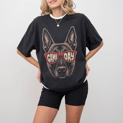 Model wearing a Black Comfort Colors® T-shirt with belgian malinois wearing red game day sunglasses