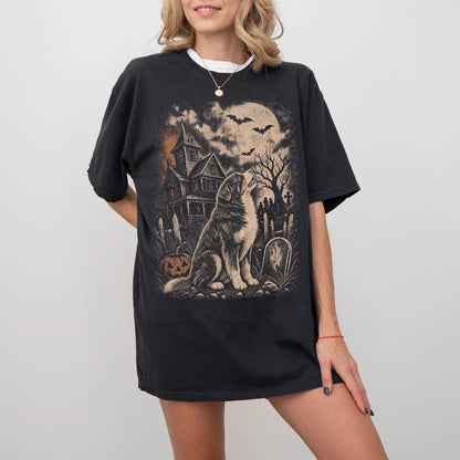 Model wearing a Black Comfort Colors® T-shirt showing Bernese Mountain Dog in a vintage haunted-house scene