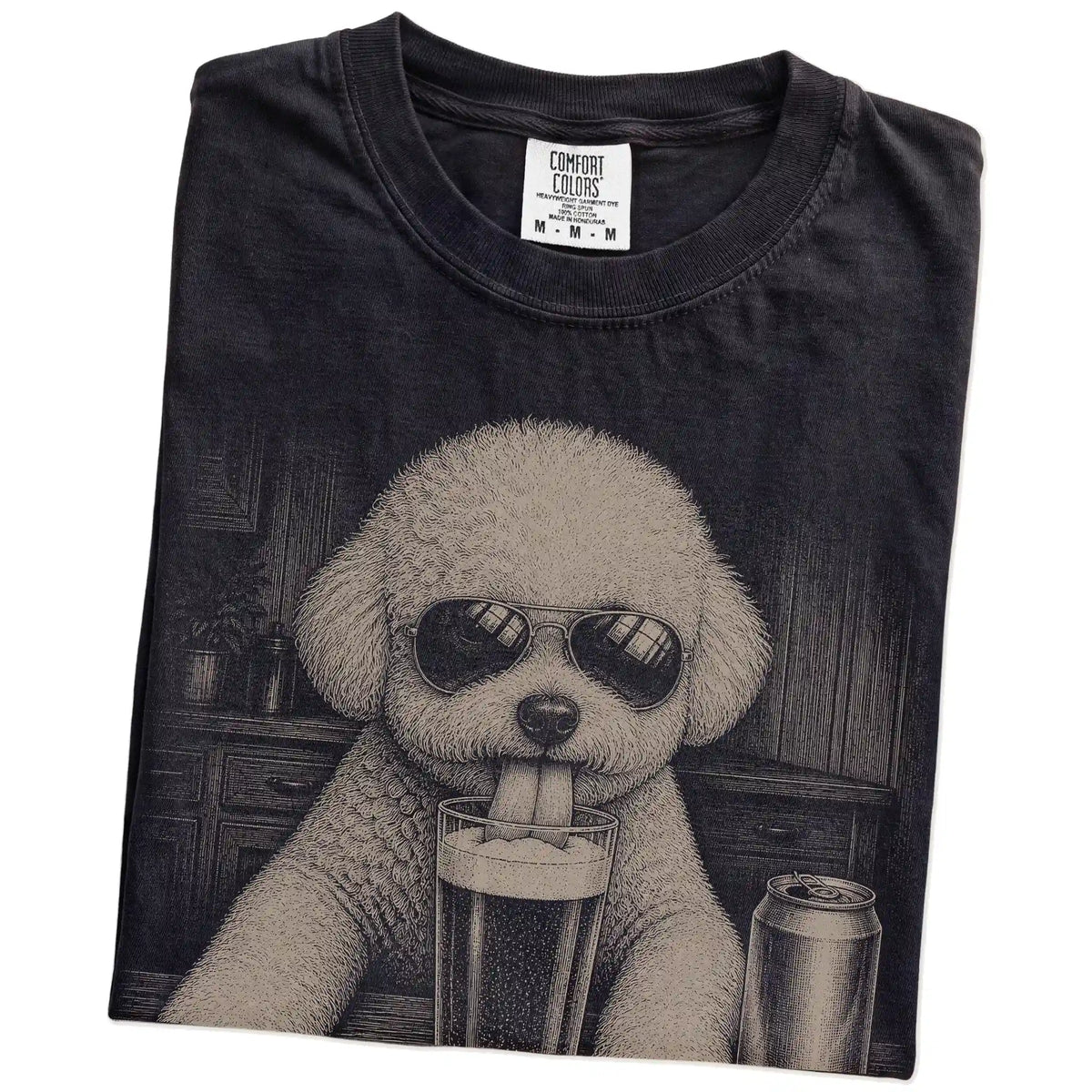 Folded Black Comfort Colors® t-shirt showing Bichon Frise sneaking a drink from a pint