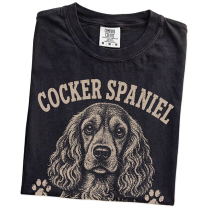 Folded Black Comfort Colors® T-shirt showing Cocker Spaniel design with “Big Feelings, Better Hair” lettering